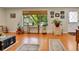 Bright living room featuring hardwood floors, a large window, and tasteful decor for a welcoming ambiance at 3266 S Wabash Ct, Denver, CO 80231