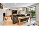 Cozy living room with wood floors, reclining couch, and a view of the backyard patio at 3266 S Wabash Ct, Denver, CO 80231