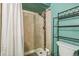 Updated bathroom with a tiled shower, shower curtain, sleek fixtures, and neutral tones at 6327 S Emporia Cir, Englewood, CO 80111