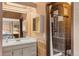 Bathroom featuring mosaic-tiled shower, vanity, and decoratively painted walls at 6327 S Emporia Cir, Englewood, CO 80111