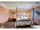 Comfortable bedroom with a four-poster bed, soft lighting, and a cozy rug on the hardwood floors at 6327 S Emporia Cir, Englewood, CO 80111