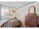 Bedroom featuring hardwood floors, large dresser, and a cozy ambiance at 6327 S Emporia Cir, Englewood, CO 80111