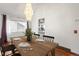 Bright dining room with wood floors, a stylish chandelier, and a view into the kitchen at 6327 S Emporia Cir, Englewood, CO 80111