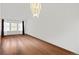 Bright dining room with wood floors, a stylish chandelier, and a large window at 6327 S Emporia Cir, Englewood, CO 80111