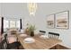 Bright dining room with wood floors, neutral furniture, and a stylish chandelier at 6327 S Emporia Cir, Englewood, CO 80111