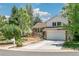 Charming two-story home with brick and siding, a landscaped yard, and an attached two-car garage at 6327 S Emporia Cir, Englewood, CO 80111