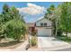 Charming two-story home with brick and siding, a red front door, and an attached two-car garage at 6327 S Emporia Cir, Englewood, CO 80111