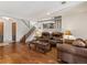 Spacious living room featuring hardwood floors, neutral decor, and staircase to upper level at 6327 S Emporia Cir, Englewood, CO 80111