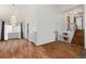 Bright living room with wood floors, a staircase, and a view into the dining room at 6327 S Emporia Cir, Englewood, CO 80111