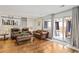 Spacious living room featuring hardwood floors, neutral decor, and sliding glass door access to patio at 6327 S Emporia Cir, Englewood, CO 80111