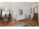 Bright living room with wood floors, a staircase, and a view into the dining room at 6327 S Emporia Cir, Englewood, CO 80111