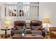 Comfortable living room featuring a leather sofa and a decorative wooden screen above seating area at 6327 S Emporia Cir, Englewood, CO 80111