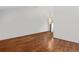 Bright living room featuring hardwood floors and hanging modern light fixture at 6327 S Emporia Cir, Englewood, CO 80111