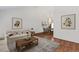 Open living room, featuring hardwood floors, area rug, neutral color palette and adjacent dining area at 6327 S Emporia Cir, Englewood, CO 80111