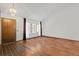 Bright living room with wood floors, a large window, a dramatic chandelier, and an exterior door at 6327 S Emporia Cir, Englewood, CO 80111