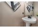 Small bathroom with a modern vanity, white sink, a mirror, and stylish art on the walls at 3974 W 118Th Pl, Westminster, CO 80031