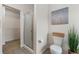 Neutral toned bathroom with a glass-enclosed shower, walk-in closet and modern commode at 3974 W 118Th Pl, Westminster, CO 80031
