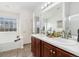 Bright bathroom with double sinks, updated fixtures, tile floors, and a soaking tub at 3974 W 118Th Pl, Westminster, CO 80031
