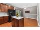 Bright kitchen featuring wood floors, an island, stainless appliances, and space for a dining room at 3974 W 118Th Pl, Westminster, CO 80031