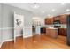 Eat-in kitchen with wood floors, modern fixtures, stainless appliances, and open floor plan at 3974 W 118Th Pl, Westminster, CO 80031