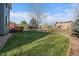 Expansive backyard with a well-maintained lawn and a classic wood fence at 10900 Parker Vista Rd, Parker, CO 80138