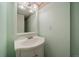 Small bathroom featuring a pedestal sink with framed mirror and decorative lighting at 10900 Parker Vista Rd, Parker, CO 80138