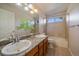 Bathroom featuring double sinks with granite countertop and tiled shower/tub at 10900 Parker Vista Rd, Parker, CO 80138