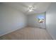 A spacious bedroom with neutral carpeting, a ceiling fan, and a bright window at 10900 Parker Vista Rd, Parker, CO 80138
