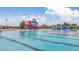 Community pool area featuring multiple slides and recreational water features under a sunny sky at 10900 Parker Vista Rd, Parker, CO 80138