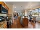 Open kitchen and dining area flow into a comfortable living space, showcasing modern appliances, ample seating, and natural light at 10900 Parker Vista Rd, Parker, CO 80138