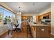 Well-lit kitchen with stainless steel appliances, granite countertops, a kitchen island, and a charming breakfast nook by the window at 10900 Parker Vista Rd, Parker, CO 80138
