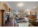Inviting living room with a cozy fireplace, open floor plan, hardwood floors, and a view into the kitchen and dining area at 10900 Parker Vista Rd, Parker, CO 80138