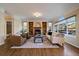 Elegant living room featuring a fireplace, built-in bookshelves, hardwood floors, and abundant natural light from large windows at 10900 Parker Vista Rd, Parker, CO 80138