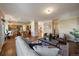 Spacious open-concept living area seamlessly connects to the kitchen and dining space, showcasing hardwood floors and ample lighting at 10900 Parker Vista Rd, Parker, CO 80138