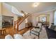 Inviting living room with hardwood floors, staircase, and archway to the dining area at 10900 Parker Vista Rd, Parker, CO 80138