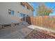 A private backyard with a patio, wood fence, and mature trees at 3738 Miller Ct, Wheat Ridge, CO 80033