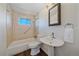 Well-lit bathroom featuring a tub/shower, vanity, mirror and modern fixtures over wood-look flooring at 3738 Miller Ct, Wheat Ridge, CO 80033