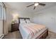 Cozy bedroom featuring a ceiling fan and comfortable decor, illuminated by natural light from the window at 3738 Miller Ct, Wheat Ridge, CO 80033