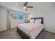 Well-lit bedroom with a cozy bed, large window and modern ceiling fan at 3738 Miller Ct, Wheat Ridge, CO 80033