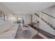Cozy living room with modern decor, seamlessly connecting to the dining area and stairs at 3738 Miller Ct, Wheat Ridge, CO 80033