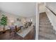 Bright living room featuring stylish decor and seamless transition to staircase at 3738 Miller Ct, Wheat Ridge, CO 80033