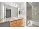 Bathroom with double vanity, full mirror, and tub shower at 8735 E 29Th Pl, Denver, CO 80238