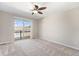 Carpeted bedroom featuring sliding glass door to balcony and a ceiling fan at 8735 E 29Th Pl, Denver, CO 80238