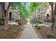Tree-lined sidewalk in a residential community with benches and landscaped grounds at 8735 E 29Th Pl, Denver, CO 80238