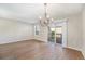 Dining room with hardwood floors, decorative chandelier, and sliding glass doors at 8735 E 29Th Pl, Denver, CO 80238