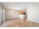 Open-concept dining room featuring hardwood floors and a view into the kitchen at 8735 E 29Th Pl, Denver, CO 80238