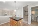 Kitchen island with granite countertop and hardwood floors at 8735 E 29Th Pl, Denver, CO 80238
