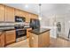 Kitchen featuring stainless steel appliances, dark countertops, and tile backsplash at 8735 E 29Th Pl, Denver, CO 80238