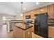 Kitchen with stainless steel appliances, center island, and hardwood floors at 8735 E 29Th Pl, Denver, CO 80238