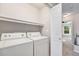 Laundry room with shelving, washer, and dryer at 8735 E 29Th Pl, Denver, CO 80238